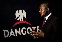 Photo of Aliko Dangote beside Dangote company logo